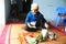 Woman making betel with betel and areca