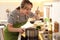 Woman making bouillon on stove. Homemade recipe