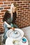 Woman making ceramic pottery on wheel, blow dry clay blanks. Concept for woman in freelance, business. Handcraft product. Earn