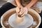 Woman making ceramic pottery on wheel, creation of ceramic ware. Concept of women`s work, craft