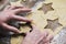 Woman making christmas gingerbread biscuits. Hand detail.