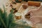 Woman making christmas gingerbread cookies, atmospheric time. Hands cutting gingerbread dough with festive golden cutters on