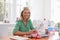 Woman Making Clothes Using Sewing Machine At Home