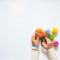 Woman making colored pompoms. View from above. White background.