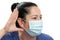 Woman making curious listening gesture wearing surgical mask