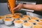 Woman during making decorating cooking bakery cake