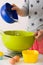 Woman making dough for muffins. Mixing flour, sugar, eggs and other ingredients from colorful bowls. Homemade food, baking at home