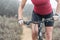 Woman making downhill with mountain bike.