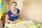 Woman making dumplings (pelmeni) in her kitchen