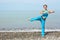 woman is making exercise on sea coast