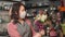 Woman making fresh bouquet in flower shop. female florist wears mask illness to prevent