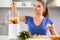 Woman making fruits smoothies with juicer machine