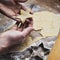 Woman making gingerbread biscuits. Hand detail. Christmas baking.