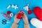 Woman making handmade traditional martisor, from red and white strings with tassel. Symbol of holiday 1 March, Martenitsa, Baba