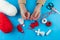 Woman making handmade traditional martisor, from red and white strings with tassel. Symbol of holiday 1 March, Martenitsa, Baba