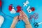 Woman making handmade traditional martisor, from red and white strings with tassel. Symbol of holiday 1 March, Martenitsa, Baba