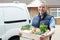 Woman Making Home Delivery Of Organic Vegetable Box