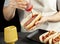 woman making hotdog sandwiches at home