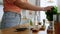 woman making mojito cocktail drink at home kitchen