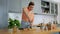 woman making mojito cocktail drink at home kitchen