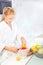 Woman making morning juice in kitchen