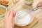 Woman making natural handmade soap at wooden table, closeup