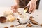 Woman making natural soap on light background