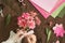 Woman making paper bouquet at wood table with color papers, scissors for valentines, holidays. Flatlay, top view