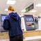 Woman Making Payment At An Automatic Check Out in Waitrose Supermarket