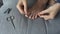 Woman is making pedicure herself removing cuticle and pterygium on toe, closeup.