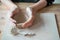 Woman making pottery, hands closeup, blurred background, focus on potters, palms with pottery. Turning passion into a job