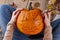 Woman making pumpkin jack for Halloween