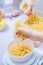 Woman making scale weighing raw penne pasta