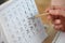 Woman making schedule using calendar at table, closeup