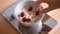 Woman Making Smile Face with Raspberries in Oatmeal Bowl on Food Scale. Healthy Breakfast for Children. 4K.