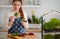 Woman making spinach and beetroot raw salad at the kitchen with micro green cultivation on background, healthy vegan organic