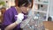 A woman making a stained glass lamp