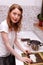 Woman making sushi in kitchen