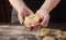 Woman making tagliatelle nest on kitchen table