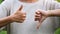 a woman making thumbs up and thumbs down hands sign
