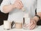 Woman making whey protein cocktail in the morning. hand holding a scoop og protein powder and mixing it with water. crop