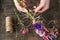 Woman making wreath with wild flowers.