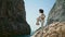 Woman making yoga asana standing rocky beach. African american girl stretching.