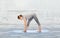 Woman making yoga intense stretch pose on mat