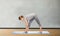 Woman making yoga intense stretch pose on mat