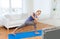 Woman making yoga low angle lunge pose on mat