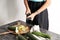 Woman making zucchini spaghetti on kitchen table