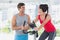 Woman with male instructor working out at spinning class