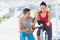 Woman with male instructor working out at spinning class