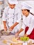 Woman man in chef hat cooking chicken.